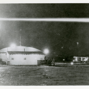 Air Mail plane on field at nighttime, 1925