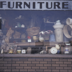Dicker's Furniture Antiques Window Closeup, 301 S Dubuque St, 1975