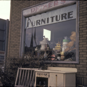 Dicker's Furniture Window Closeup, 301 S Dubuque St, 1975